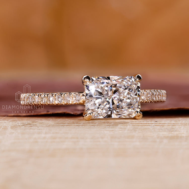Claw prong ring setting featuring a radiant cut diamond for a bold, elegant statement.
