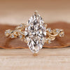 Marquise engagement ring with round side stones.