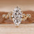 Marquise engagement ring with round side stones.