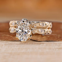 Marquise and round side stone with milgrain details and vintage style.