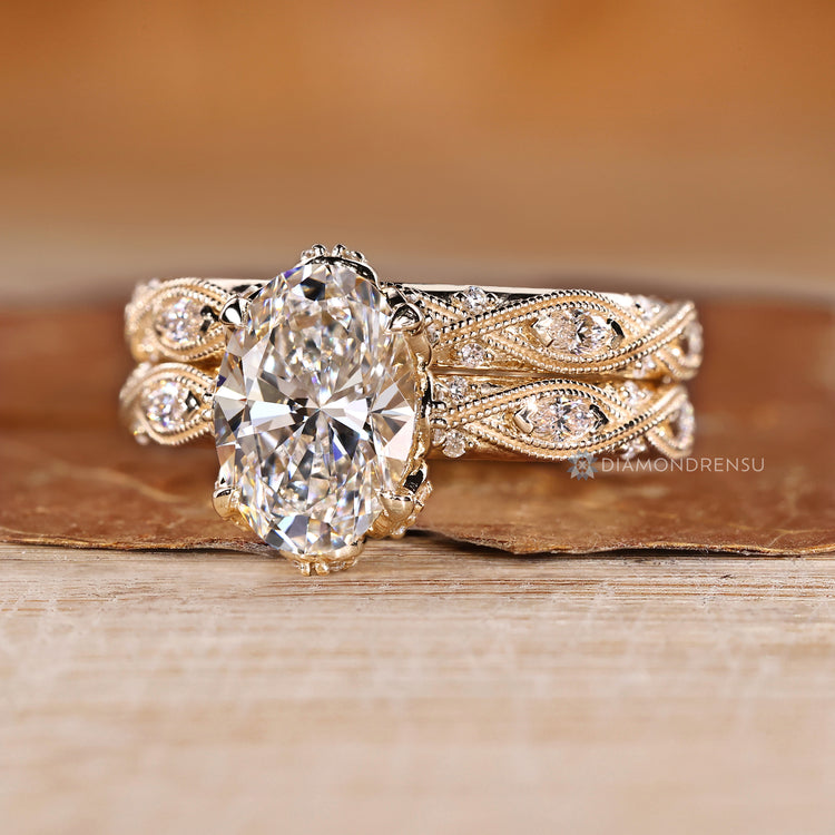 Marquise and round side stone with milgrain details and vintage style.