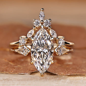 Marquise cut wedding ring with kite side stones and three stone style.