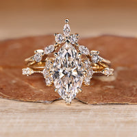 Marquise wedding ring with round side stones and vintage style.