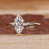 Tapered shank marquise diamond ring with pear sides.