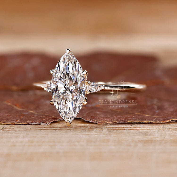 Tapered shank marquise diamond ring with pear sides.