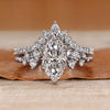 Marquise wedding ring with round side stones and prongs.