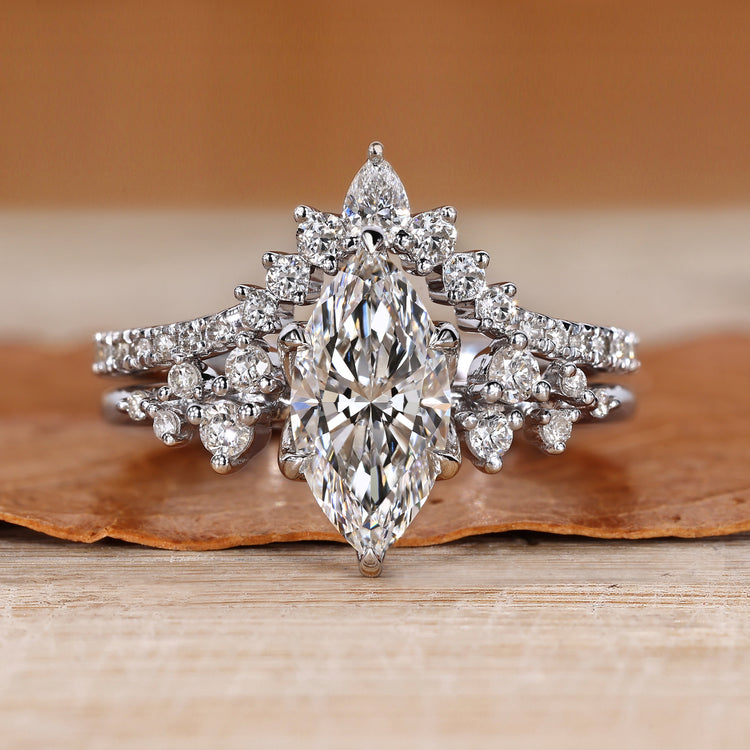 Marquise wedding ring with round side stones and prongs.