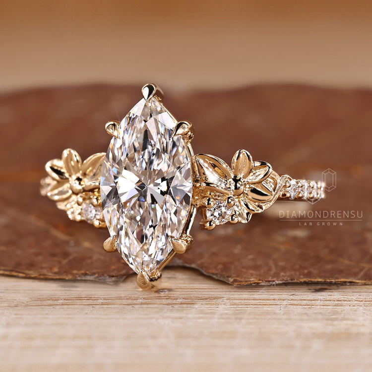 Handmade marquise engagement ring with flower design and pave band.