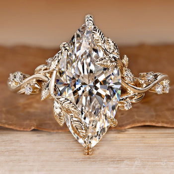Marquise diamond ring with round side stones.