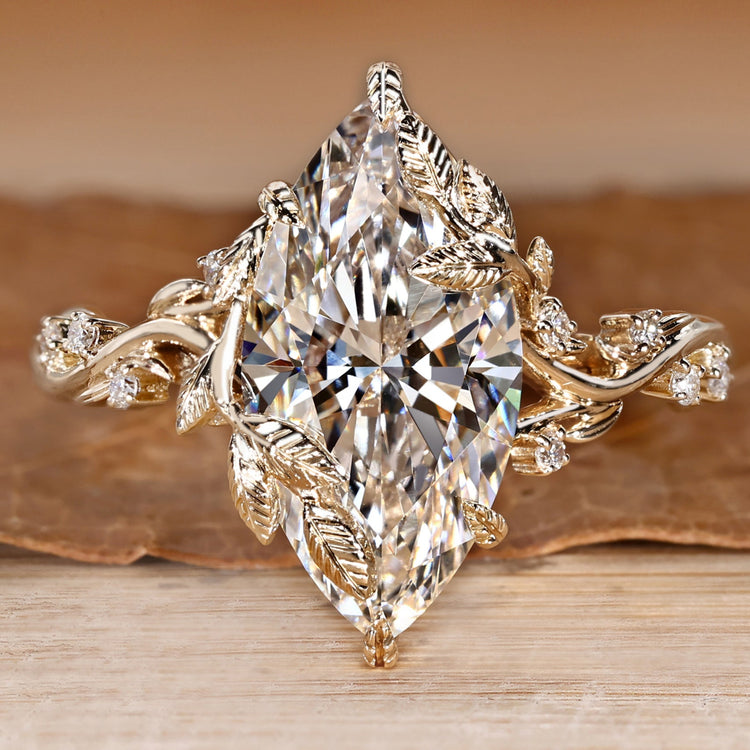 Marquise diamond ring with round side stones.