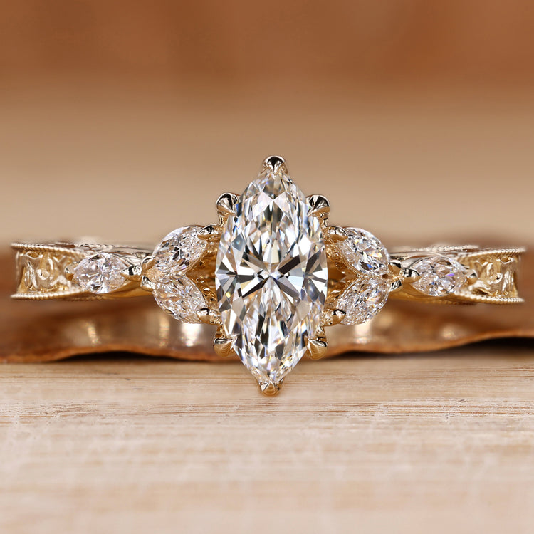 Marquise engagement ring with marquise side stones and milgrain details.