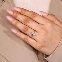 Marquise cut diamond ring with round diamond side stones.