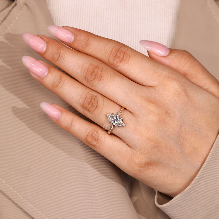 Marquise cut diamond ring with round diamond side stones.