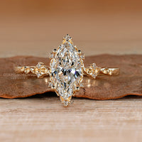 Marquise cut lab grown diamond ring with round side stones.