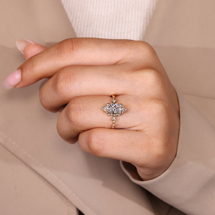 Nature inspired marquise ring with round diamond side stones.