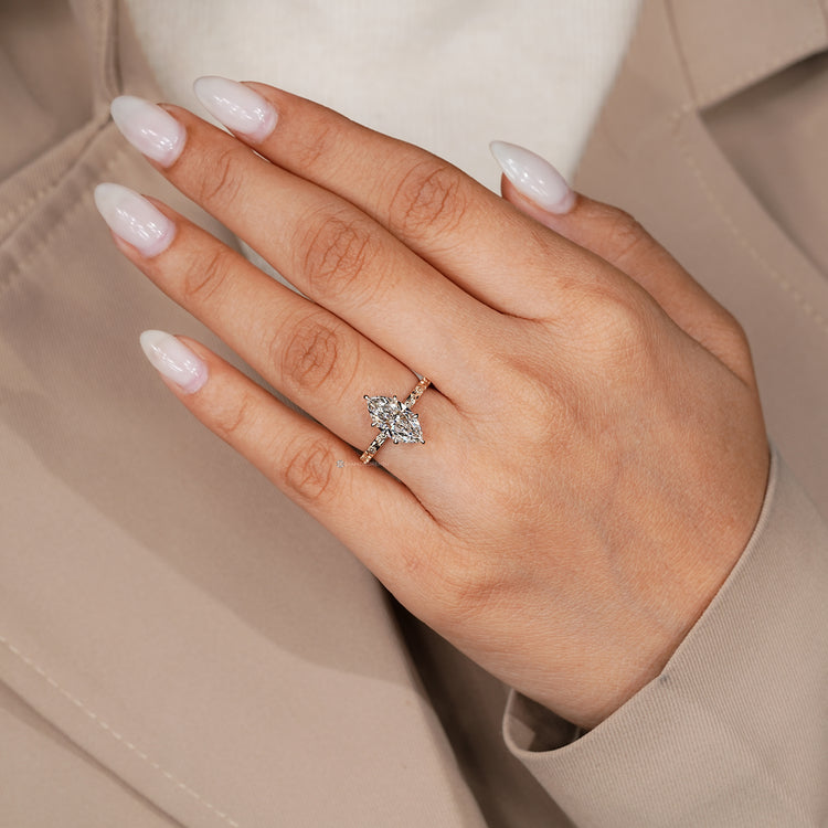 Marquise solitaire diamond ring with six claw prongs.