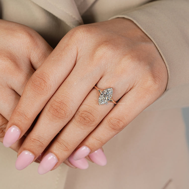 Marquise solitaire ring with milgrain details.