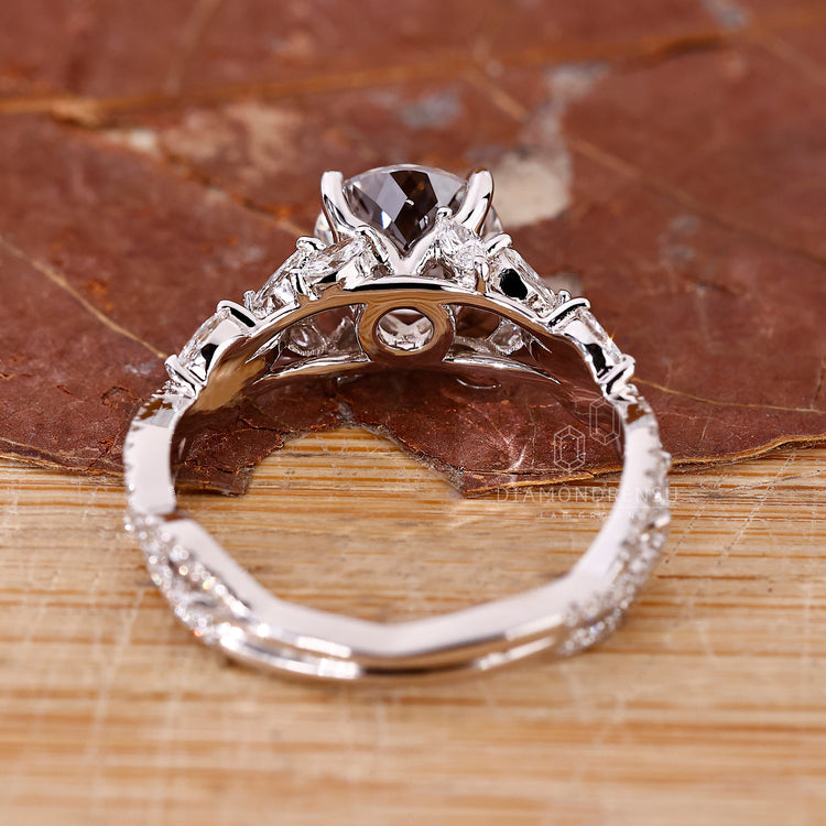 Four prong Portuguese cut diamond ring with marquise side stones.