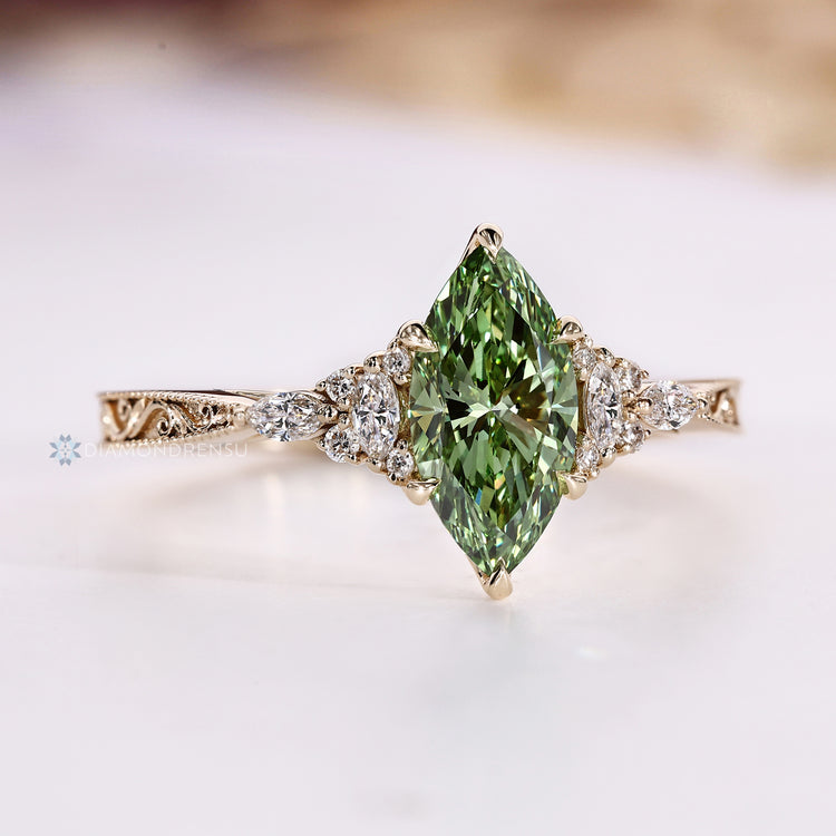 Green marquise diamond ring with a Muse setting.