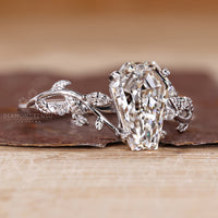 IGI certified coffin cut diamond ring with leaf style prong setting.