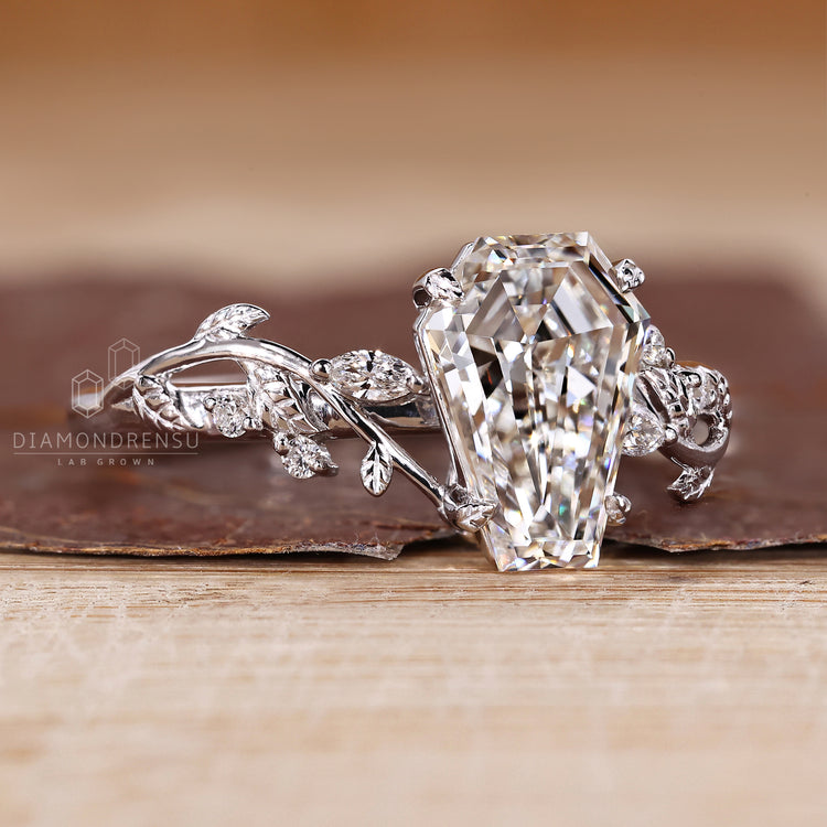 IGI certified coffin cut diamond ring with leaf style prong setting.