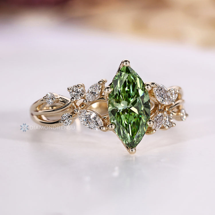 Green marquise diamond ring with a six prong setting.