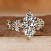 Nature inspired engagement ring with marquise side stones.
