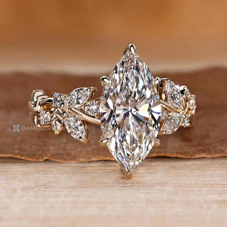 Nature inspired engagement ring with marquise side stones.