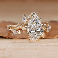 Pear cut diamond ring with marquise side stones.