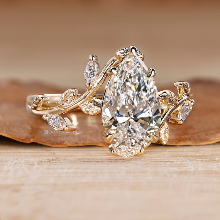 Pear cut diamond ring with marquise side stones.