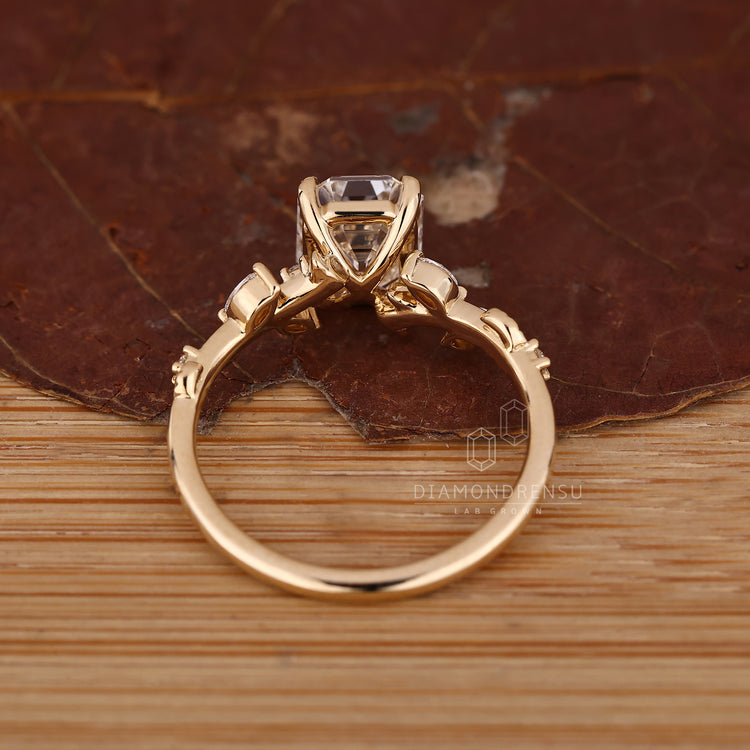 Nature inspired ring with emerald old european cut diamond and side stones.
