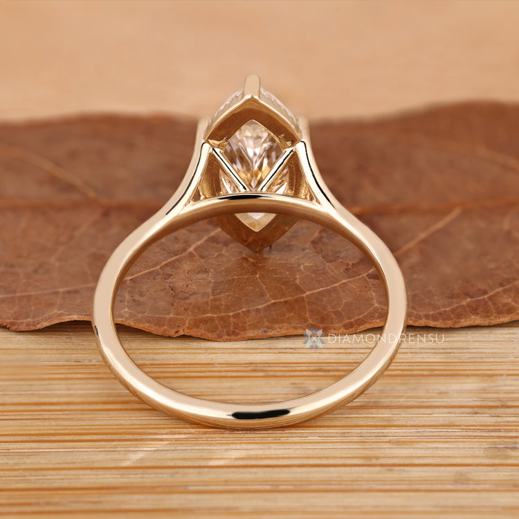 Marquise diamond ring with milgrain details and six claw prongs.