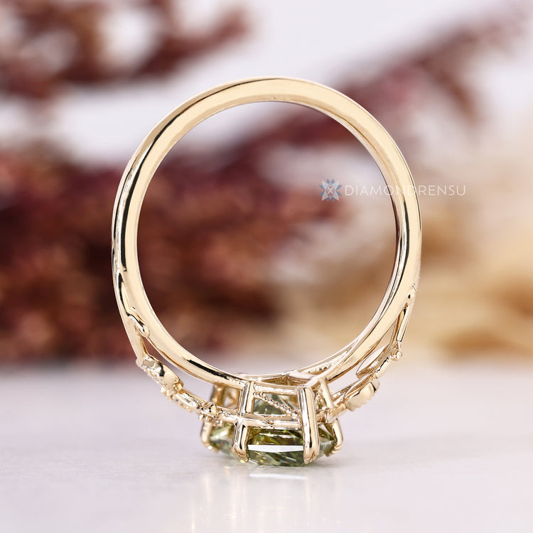 Green Dutch marquise diamond ring with round side stones and milgrain details.
