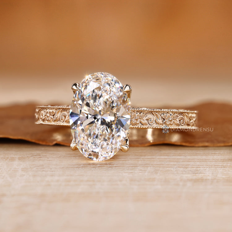 Lab grown diamond with oval center stone and milgrain details.