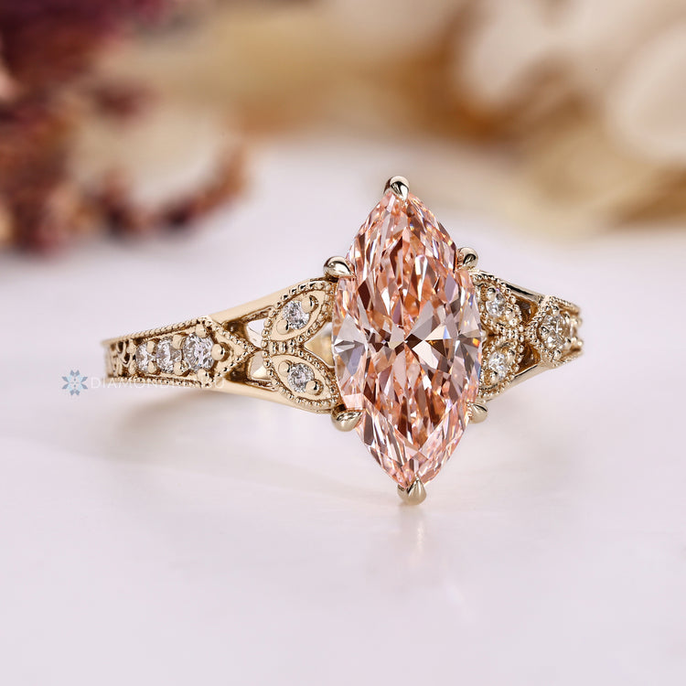 Round side stones with marquise shape outline and tapered shank.