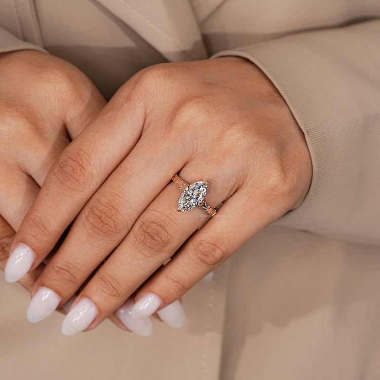 Marquise diamond ring with a tulip setting and milgrain details.