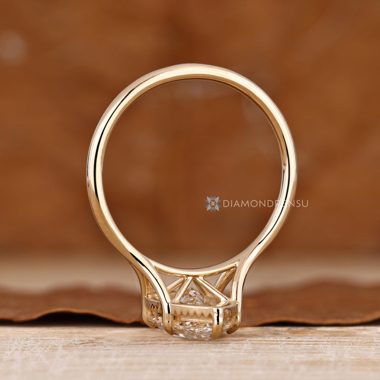 Marquise diamond ring with a split shank and milgrain details.