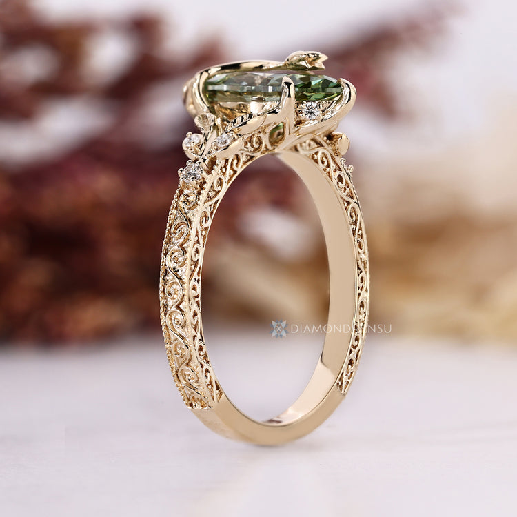 Art Deco marquise ring with milgrain details and round side stones.