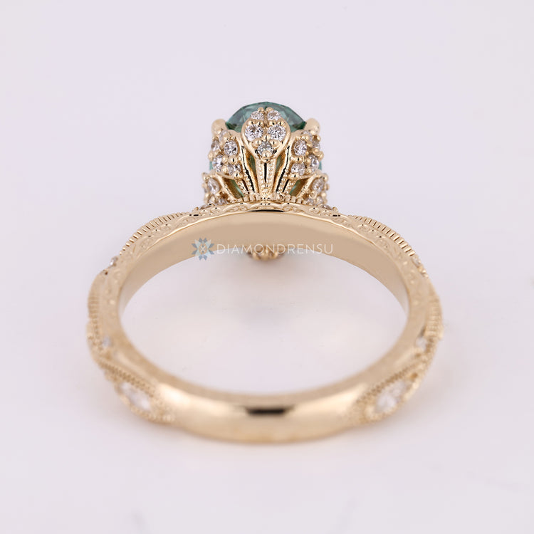 Handmade oval ring with marquise shaped round diamond outline.