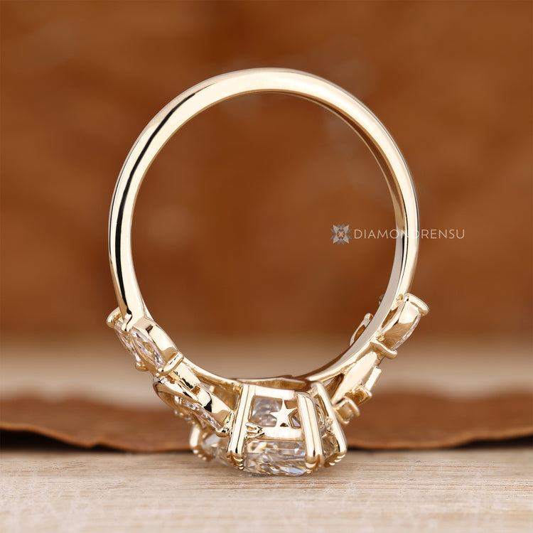 Dutch marquise ring with round side stones and a six leaf style prong setting.
