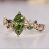 Green marquise engagement ring with Moss Agate side stones.