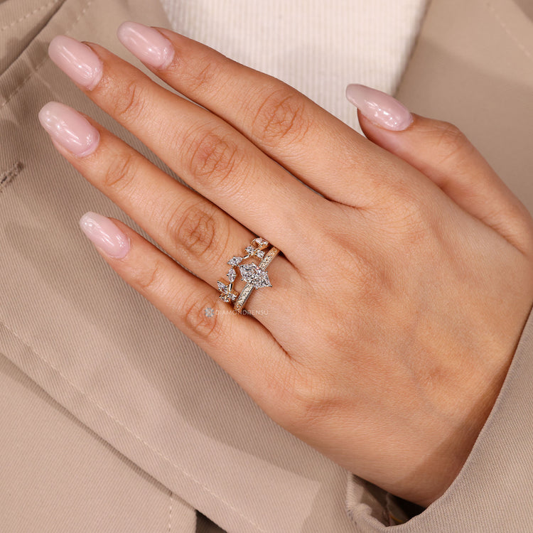 Marquise and round diamond ring with cluster setting.