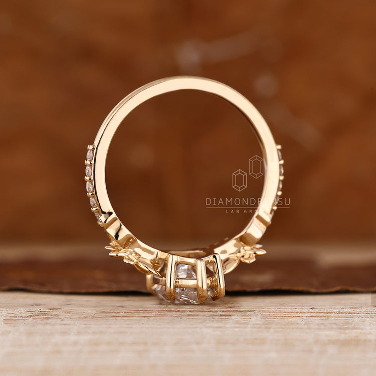 Nature inspired marquise engagement ring with round side stones.