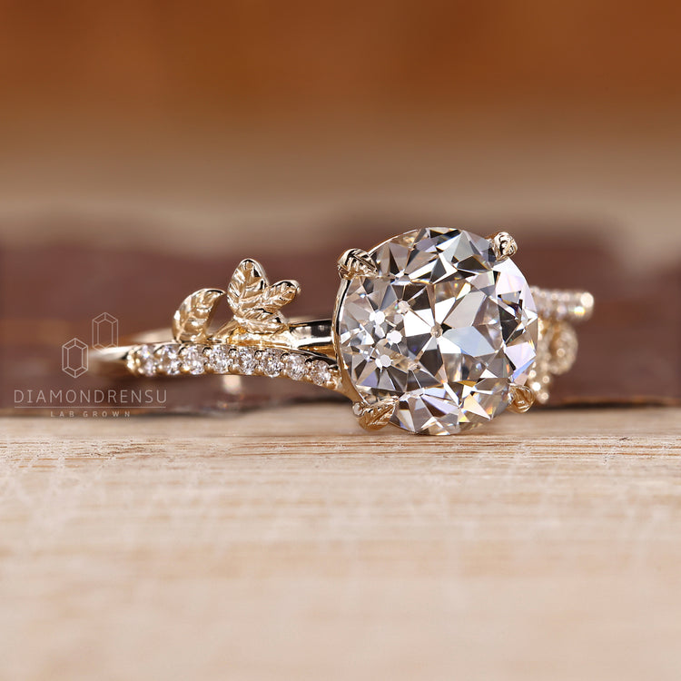 Leaf design ring with round old european cut diamond and pave setting.
