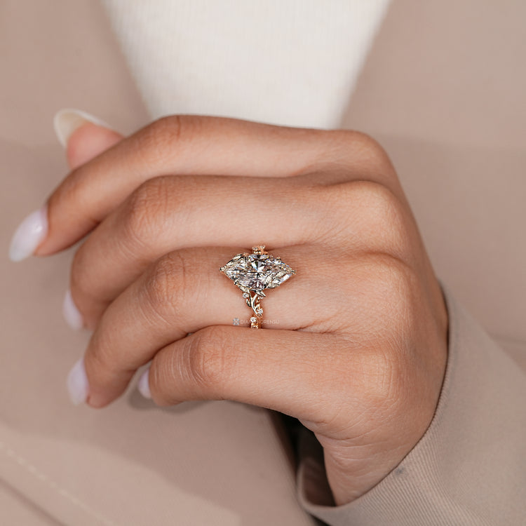 Marquise engagement ring with round diamond side stones.