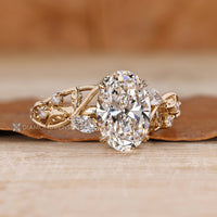 Four leaf style prong setting secures the oval center stone.