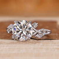 Nature inspired engagement ring with four leaf style prong setting.