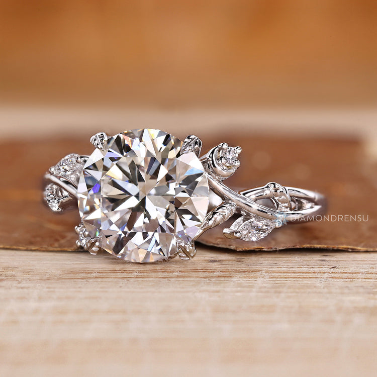 Nature inspired engagement ring with four leaf style prong setting.