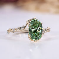 Green oval engagement ring with a tulip setting.