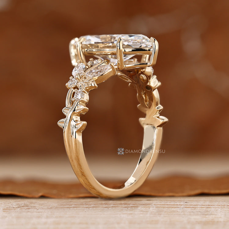 Nature inspired marquise engagement ring with round side stones.